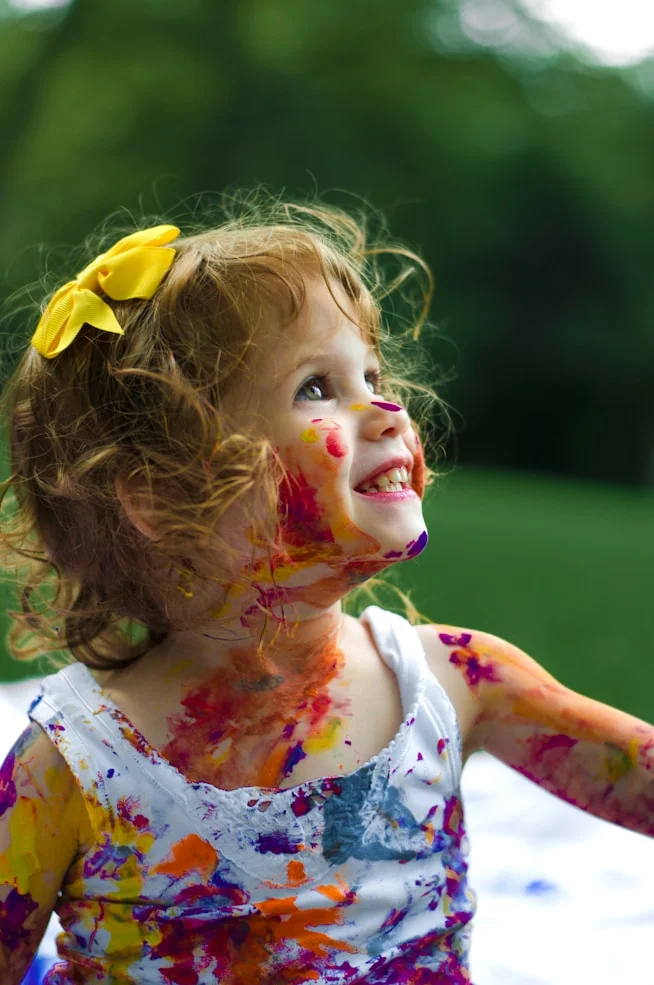Child smiling with paint on face