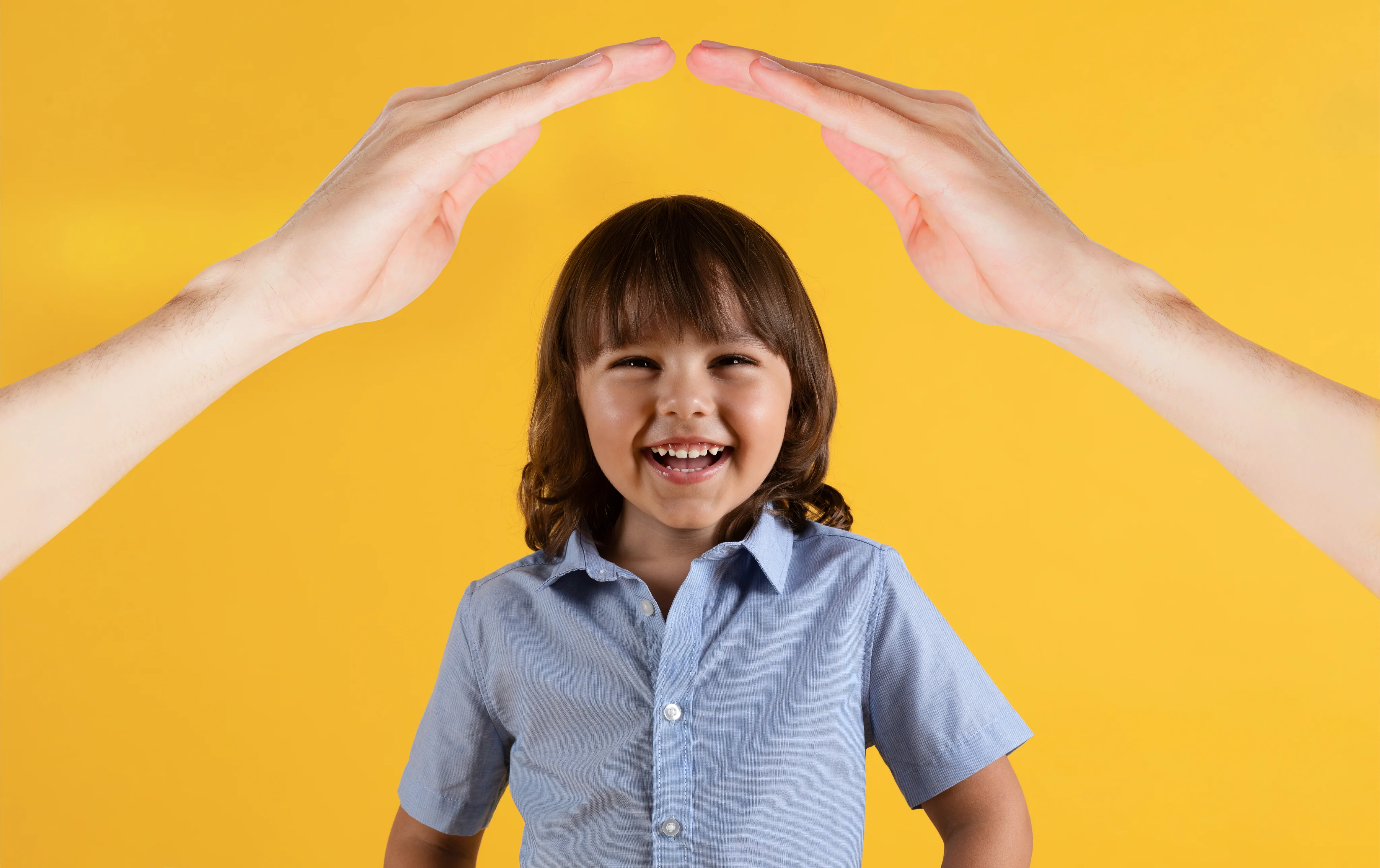 Child with hands raised above head